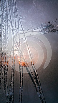 Ice flowers on the window. very low temperatures in the morning during the winter season. traces of frost on the glass