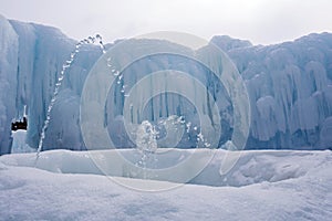 Ice formations made out of delicate icicles with a fountain in foreground