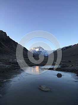 Ice in front of Rongbuk Monastery during Sunrise in Himalayan Mountains in Tibet in China.