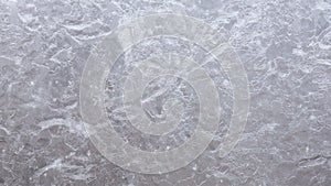 Ice and frost forms on glass window, during cold Winter. Background, pond, lake, freeze, close up, time lapse