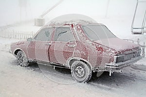 Ice frost on frozen car in winter