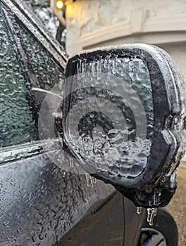 Ice on a frozen car mirror on a cold day