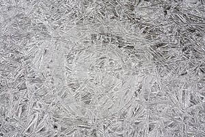 Ice on frozen river forming crystal like structures, closeup macro detail from above - abstract winter background