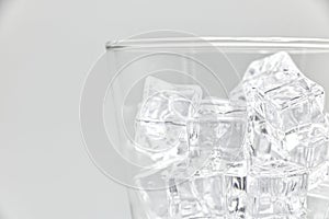 Ice in glass closeup on a white background