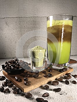 Ice Green Tea Coffee background with coffee beans in wood bowl