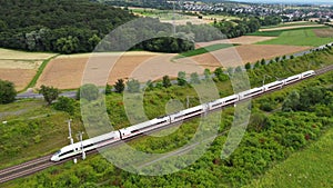 An ICE highspeed train passing by - aerial view from above, tracking sho