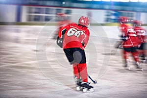 Ice hockey- boy skating on the rink