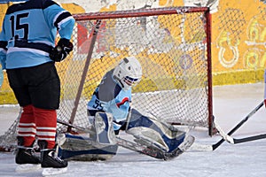 Ice hockey goalie in front of his net. Picture taken in ice arena.