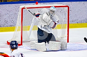 Ice hockey goalie makes a save