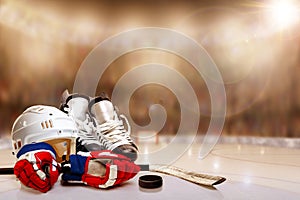 Ice Hockey Helmet, Skates, Gloves, Stick and Puck in Rink photo