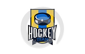 Ice hockey logo, emblem. Colorful puck emblem on the background of the shield. Sports club, team logo template. Badge