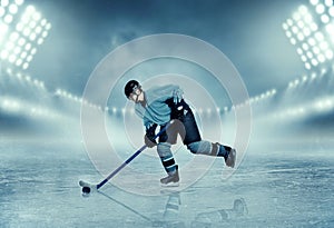 Ice hockey player in equipment poses on stadium