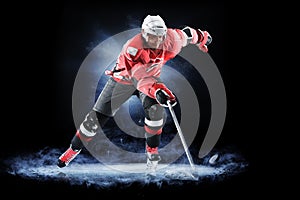 Ice hockey player isolated on black background