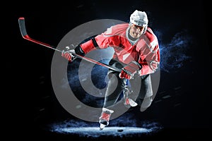 Ice hockey player isolated on black background