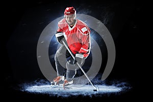 Ice hockey player isolated on black background