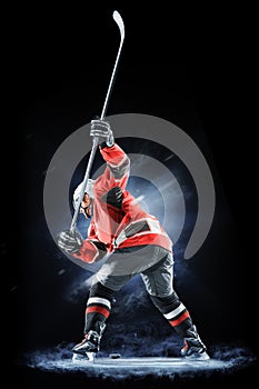 Ice hockey player isolated on black background