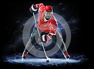 Ice hockey player isolated on black background