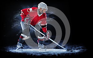 Ice hockey player isolated on black background