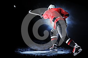 Ice hockey player isolated on black background