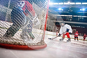 Ice hockey player shoots the puck on goal