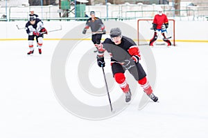 Ice hockey player with stick skating on the rink.