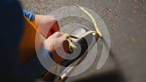 Ice hockey player ties the laces on his skates in locker room before a game, close up. Cloakroom. Male teen get dressed