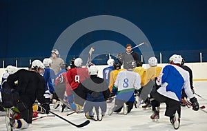 Ice hockey players team meeting with trainer