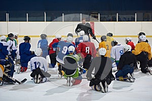 Ice hockey players team meeting with trainer