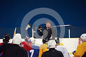 Ice hockey players team meeting with trainer