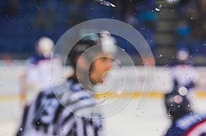 Ice hockey referee over the plexi glass - championship professional game editorial photo