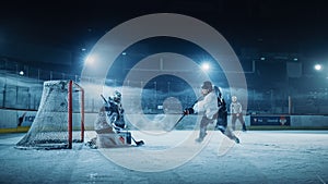 Ice Hockey Rink Arena: Goalie against Forward Player who Does Slapshot, Shoots Puck with Stick photo