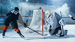 Ice Hockey Rink Arena: Goalie Against Forward Player who is Doing Slapshot, Shots Puck with Stick