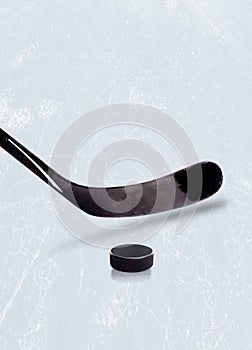 Ice hockey stick and puck on ice with copy space.