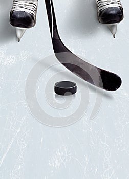 Ice hockey stick and puck on ice with copy space. photo