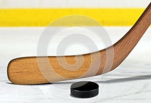 Ice hockey stick and puck on rink