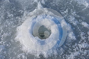 Ice hole drilled with a fishing auger