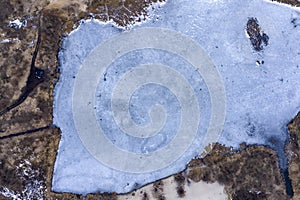 Ice hole, frozen lake, aerial view