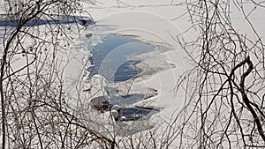 Ice-hole in a frozen lake in Mont Saint Bruno na national park, Quebec