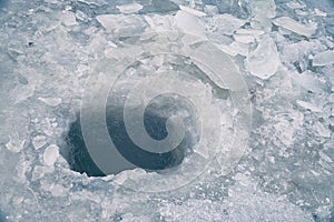 Ice hole in ice for winter fishing