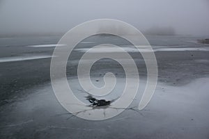 Ice-Hole In Misty Frozen Lake Winter