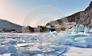 Ice hummocks on Lake Baikal near a small village