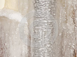 Ice and icicles on a drainpipe. Drainpipe covered with ice and icicles.