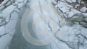 Ice at the lake by rocky shore. Aerial View. British Columbia landscape. Canada. Nature Background