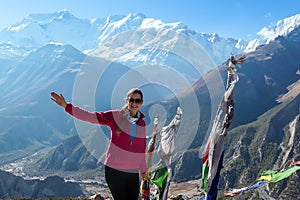 Ice Lake - A woman standing next to a row of prayer flags