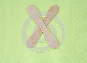 Ice lolly sticks on green napkin