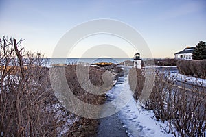 Ice on Marginal way in Ogunquit by the lobster point lighthouse in Maine in winter