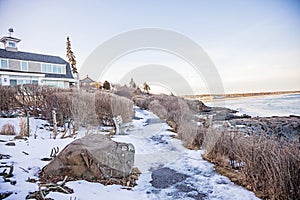 Ice on Marginal way in Ounquit on rocky coast of Maine on Atlantic Ocean in winter