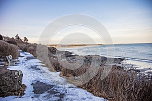 Ice on Marginal way in Ounquit on rocky coast of Maine on Atlantic Ocean in winter photo