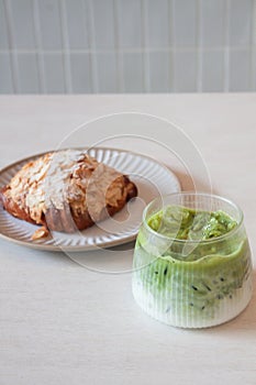 Ice matcha green tea served with croissant