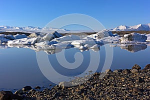 Ice meltdown with reflection in water, Iceland.